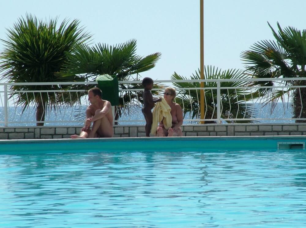 Photo of naturists in an outdoor pool - Nudism is often equated with naturism