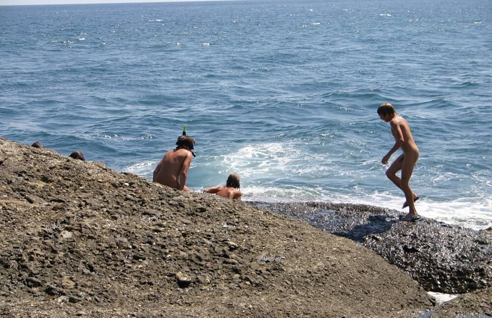 Leaning Against Hit Rocks pics - A nudist values trust and honesty between people